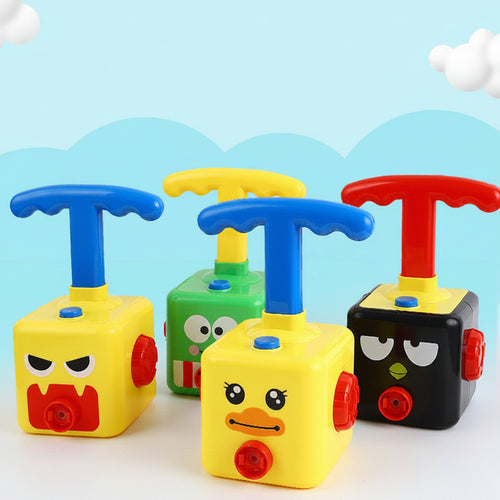 Colorful balloon-powered toy with cartoon faces on a light blue background